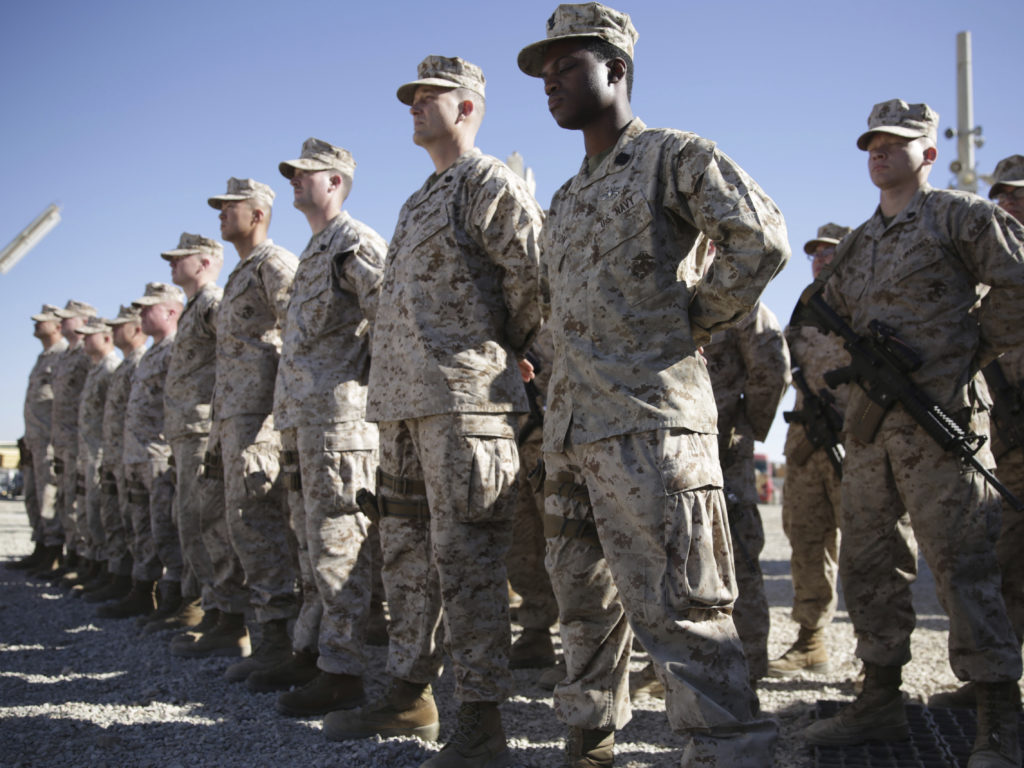 U.S. Marines stand guard during the change of command ceremony at Shorab military camp in Afghanistan's Helmand province in January 2018. CREDIT:; Massoud Hossaini/AP