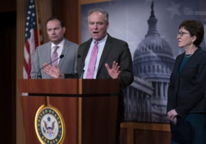 Sen. Tim Kaine, D-Va., (center), Sen. Mike Lee, R-Utah, and Sen. Susan Collins, R-Maine, have been pushing a bipartisan resolution to limit the president's war powers regarding Iran. CREDIT: J. Scott Applewhite/AP