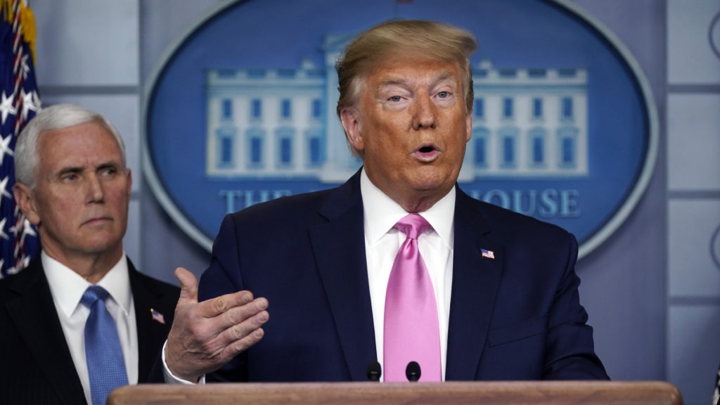 President Trump speaks as Vice President Pence listens during a Wednesday news conference about the U.S. response to the new coronavirus. CREDIT: Evan Vucci/AP