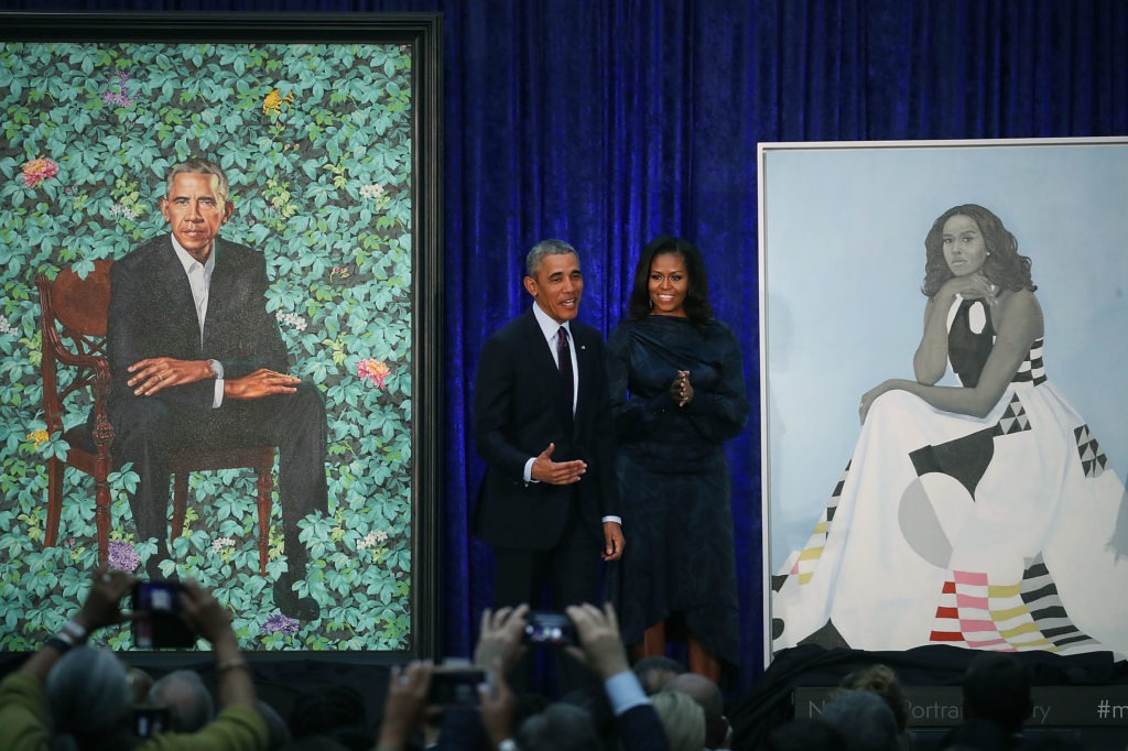 Former President Barack Obama and former first lady Michelle Obama stand next to their newly unveiled portraits during a ceremony at the Smithsonian's National Portrait Gallery on Feb. 12, 2018. The portraits are set to go on a yearlong tour to five cities in June of 2021. Mark Wilson/Getty Images