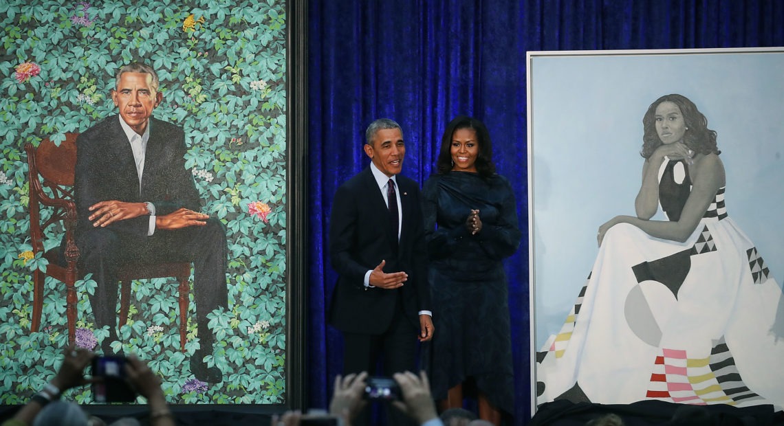 Former President Barack Obama and former first lady Michelle Obama stand next to their newly unveiled portraits during a ceremony at the Smithsonian's National Portrait Gallery on Feb. 12, 2018. The portraits are set to go on a yearlong tour to five cities in June of 2021. Mark Wilson/Getty Images