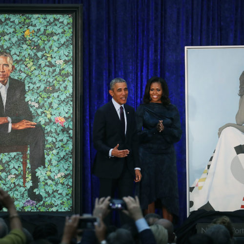 Former President Barack Obama and former first lady Michelle Obama stand next to their newly unveiled portraits during a ceremony at the Smithsonian's National Portrait Gallery on Feb. 12, 2018. The portraits are set to go on a yearlong tour to five cities in June of 2021. Mark Wilson/Getty Images