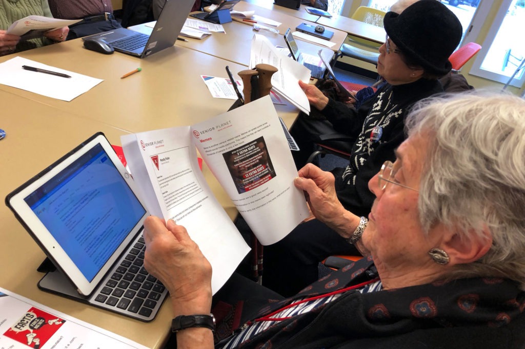 Marlene Cianci looks at a meme about the census. The workshop helps seniors parse the source of an article, fact-check a claim online and discern propaganda from reputable sources. Sam Gringlas/NPR