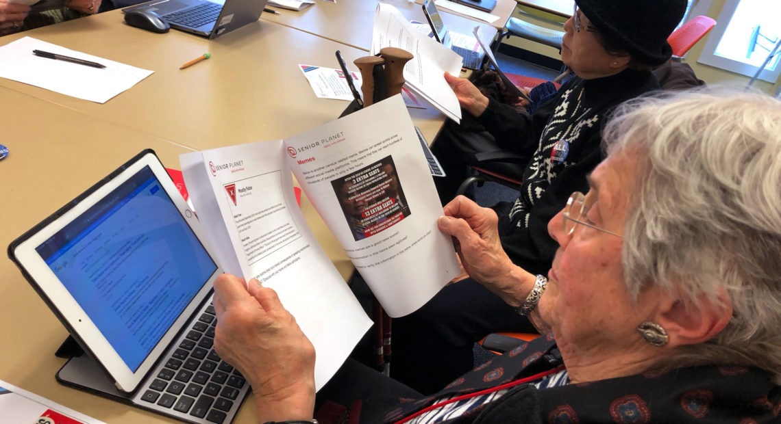 Marlene Cianci looks at a meme about the census. The workshop helps seniors parse the source of an article, fact-check a claim online and discern propaganda from reputable sources. Sam Gringlas/NPR