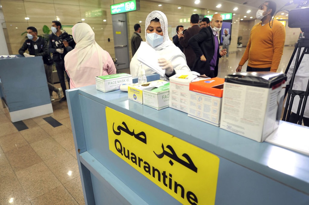 Employees of the Egyptian Quarantine Authority prepare to scan the body temperature of incoming travelers at Cairo International Airport. AFP via Getty Images