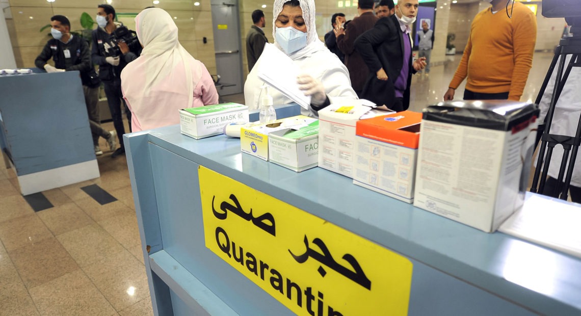 Employees of the Egyptian Quarantine Authority prepare to scan the body temperature of incoming travelers at Cairo International Airport. AFP via Getty Images