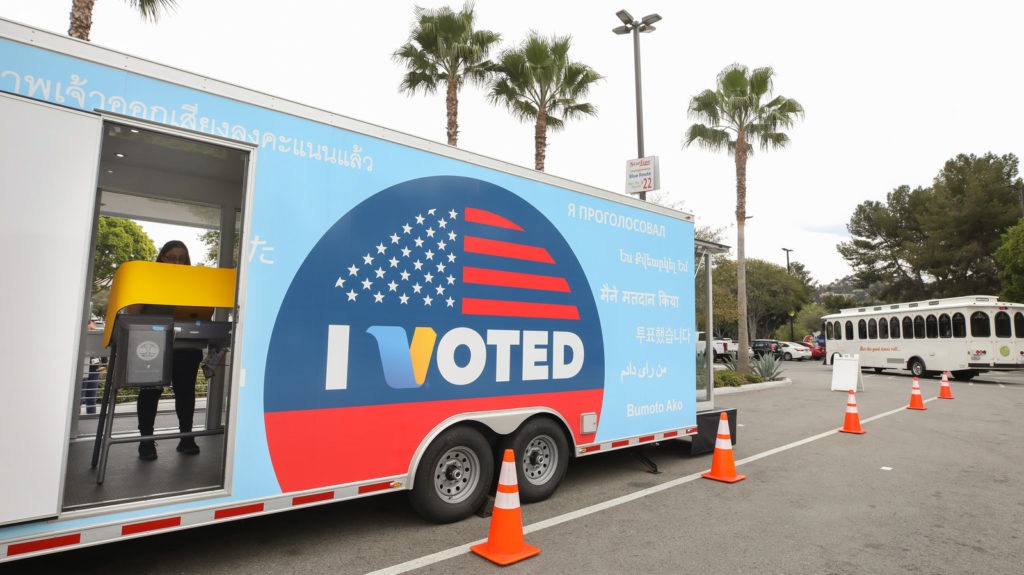 A voter prepares her ballot during early voting for the California presidential primary election at a new LA County "Mobile Vote Center" outside Universal Studios Hollywood on Thursday. Large numbers of Californians vote early and by mail, which can slow election night vote counting. CREDIT: Mario Tama/Getty Images