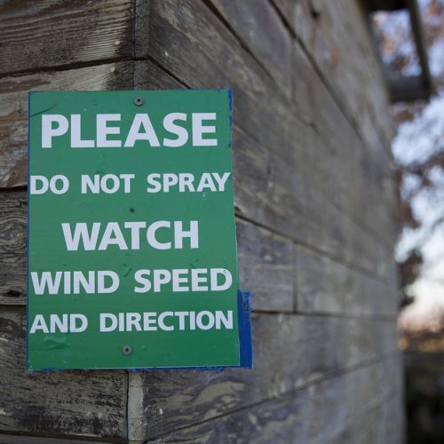 File photo. A sign at the property of Eric and Mari Perez in Qunicy, Washington, where houses are surrounded by apple orchards. Some people don't want the pesticide chlorpyrifos drifting from orchards to their property. CREDIT: Megan Farmer/KUOW