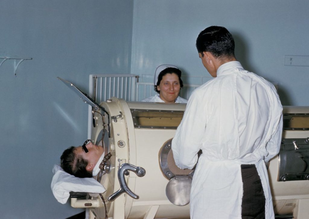 A polio patient in an iron lung, 1960. Photo via CDC