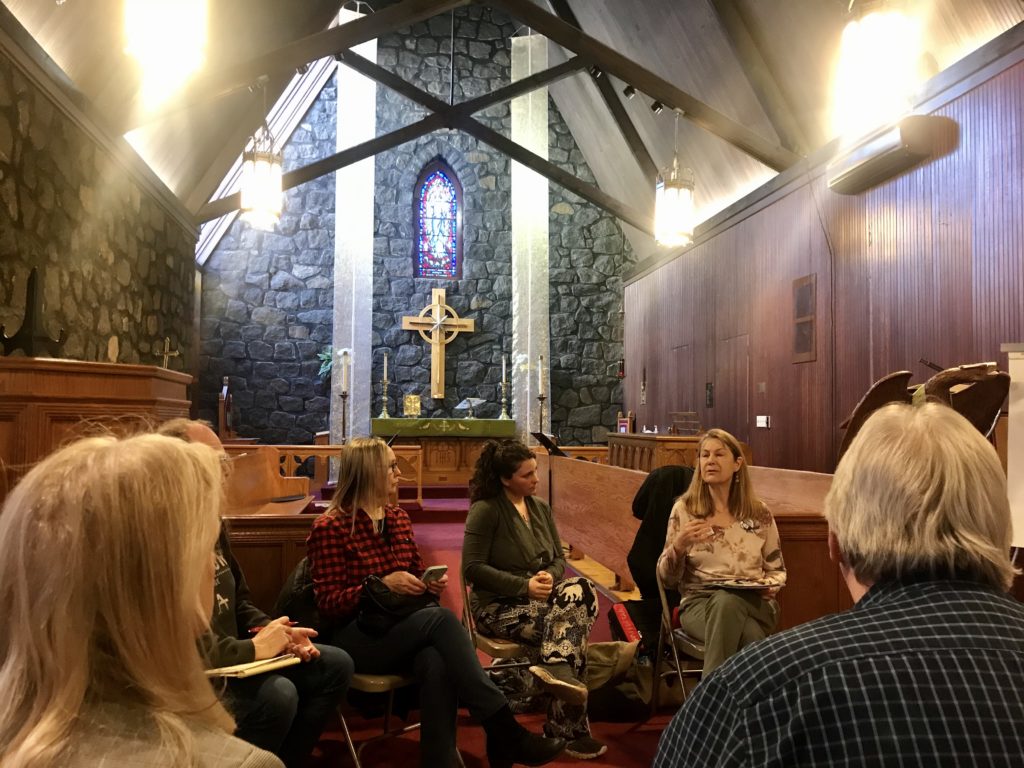 Shalom United Church of Christ member Lora Rathbone helps run the church’s social action table. She answers people’s questions about environmental advocacy and provides information about legislative bills the church supports. CREDIT: Courtney Flatt/NWPB