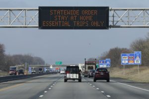 A highway sign in Carmel, Ind., urges resident to stay home as the state ordered residents to remain at home except for essential activities. Similar signs are up in many states, including Washington, after governors have issued their own orders limiting business and travel. CREDIT: Michael Conroy/AP