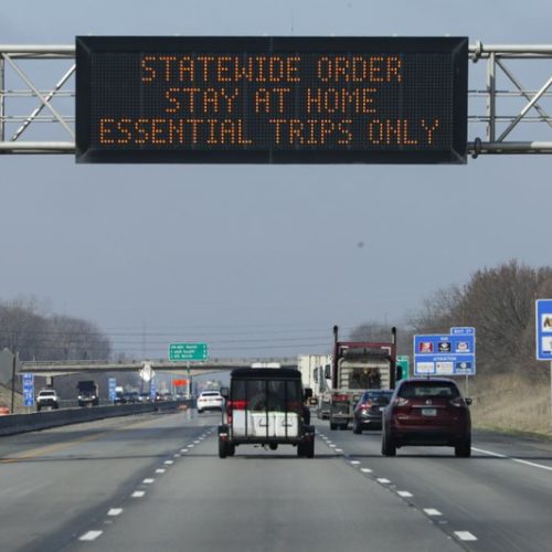 A highway sign in Carmel, Ind., urges resident to stay home as the state ordered residents to remain at home except for essential activities. Similar signs are up in many states, including Washington, after governors have issued their own orders limiting business and travel. CREDIT: Michael Conroy/AP