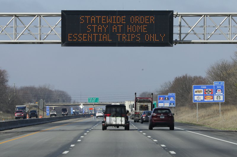 A highway sign in Carmel, Ind., urges resident to stay home as the state ordered residents to remain at home except for essential activities. Similar signs are up in many states, including Washington, after governors have issued their own orders limiting business and travel. CREDIT: Michael Conroy/AP