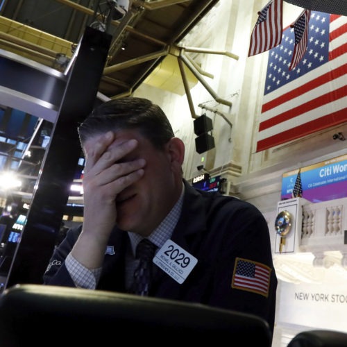 A trader reacts on the floor of the New York Stock Exchange on Monday. Major U.S. stock indexes plunged 7% before trading was temporarily halted. Richard Drew/AP