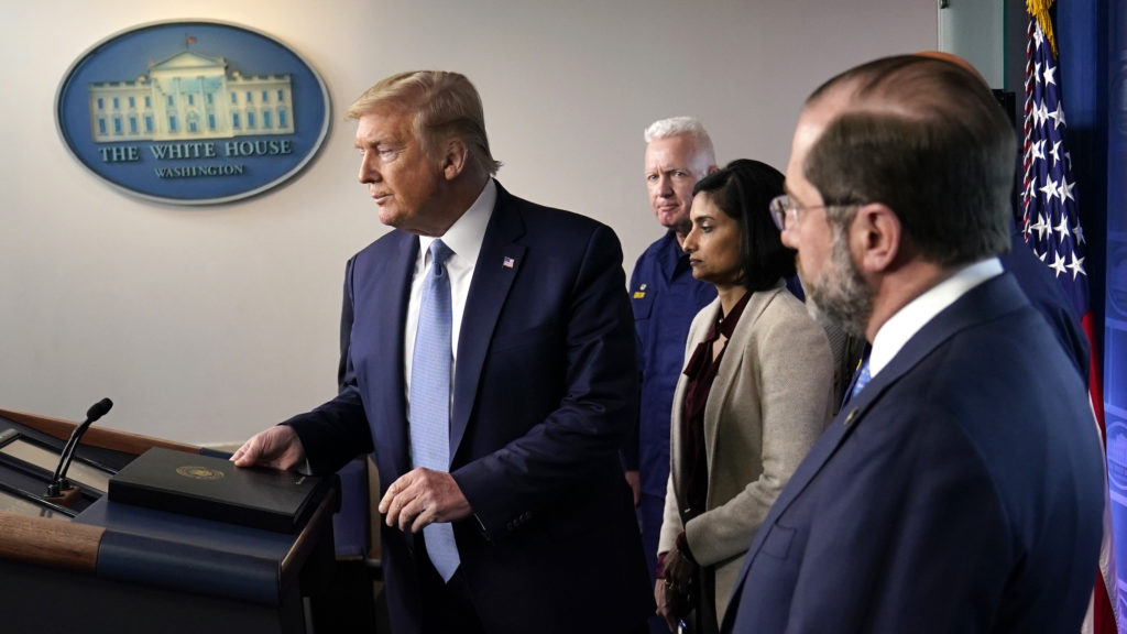 President Trump arrives to speak at a news briefing with the coronavirus task force on Monday in the White House press briefing room. Evan Vucci/AP