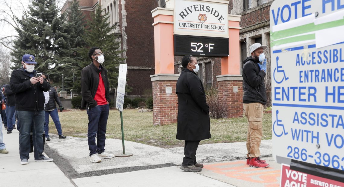 Voters line up at Riverside High School for Wisconsin's primary election on April 7 in Milwaukee, amid concerns about the spread of the coronavirus. CREDIT: Morry Gash/AP