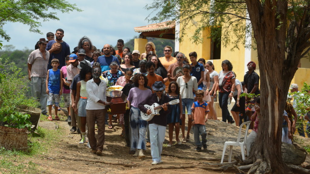 Mourners gather for a heartfelt burial ceremony in the Brazilian film Bacurau. Victor Juc /Kino Lorber