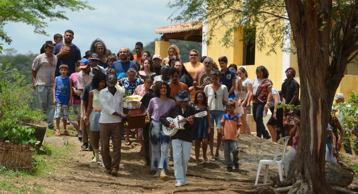 Mourners gather for a heartfelt burial ceremony in the Brazilian film Bacurau. Victor Juc /Kino Lorber