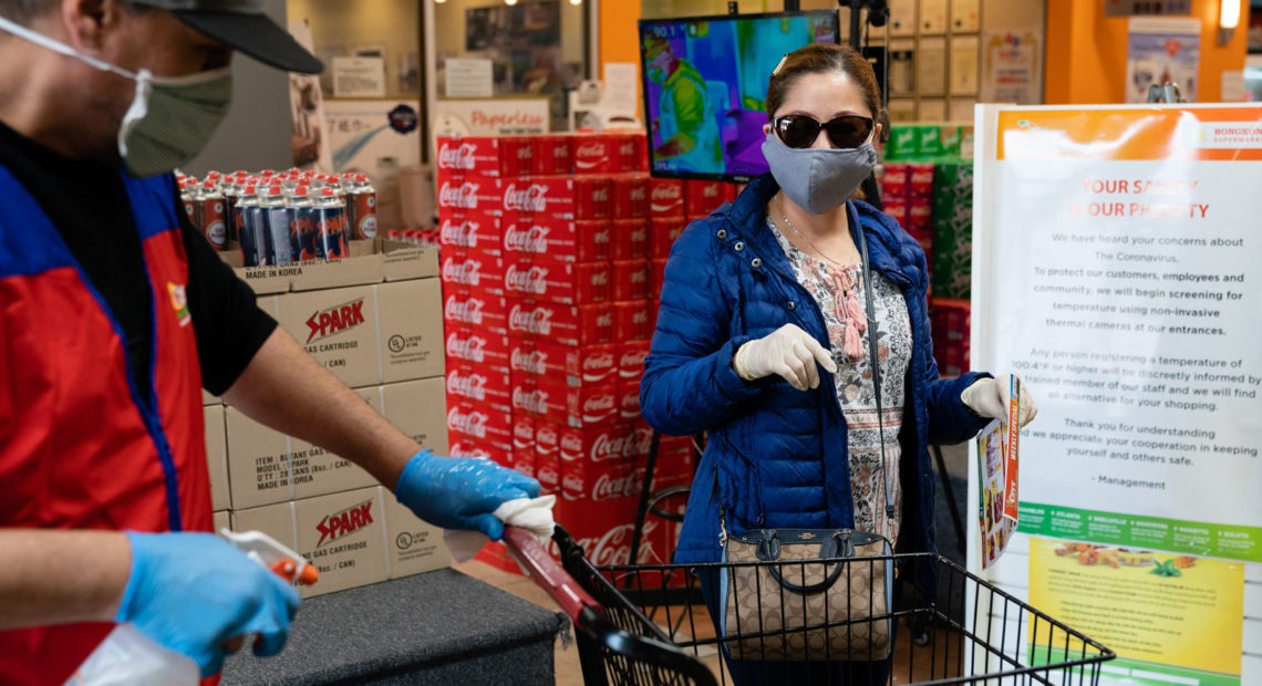 Even without symptoms, you might have the virus and be able to spread it when out in public, say researchers who now are reconsidering the use of surgical masks. CREDIT: Elijah Nouvelage/Bloomberg via Getty Images