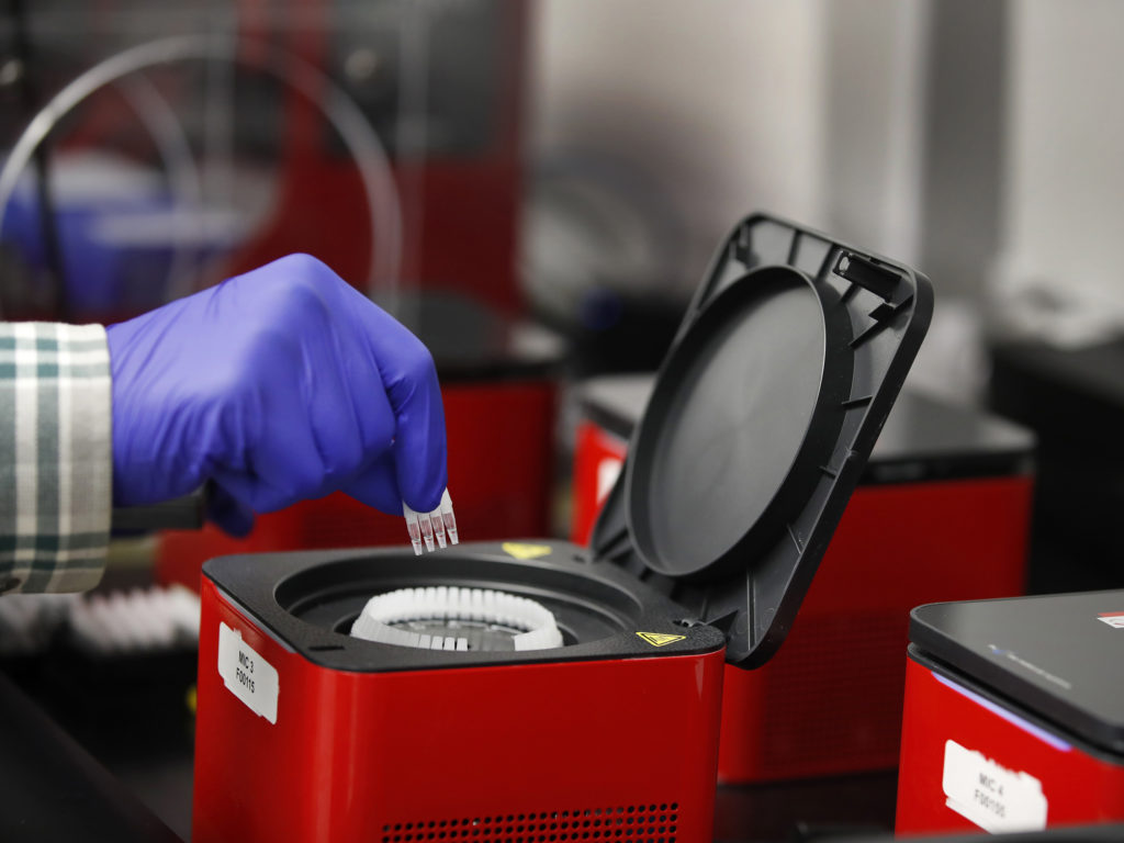 A lab technician adds vials to a Covid-19 polymerase chain reaction testing device at a Co-Diagnostics facility in Salt Lake City. George Frey/Bloomberg via Getty Images