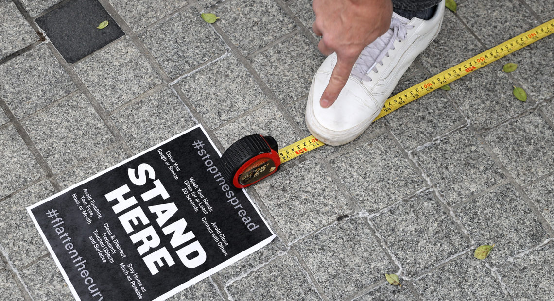 Workers use a tape measure mark spaces six feet apart for people to wait in line safely as they convert the outdoor plaza in front of Zaytinya, one of Chef José Andres' restaurants in Washington, D.C. Efforts to contain the coronavirus are affecting blood donor drives and supplies. CREDIT: Chip Somodevilla / Getty Images