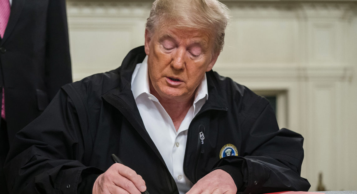 President Trump signs an $8.3 billion emergency spending bill in the White House Friday. That's significantly more than he originally requested from Congress. CREDIT: Jim Lo Scalzo/EPA/Bloomberg via Getty Images