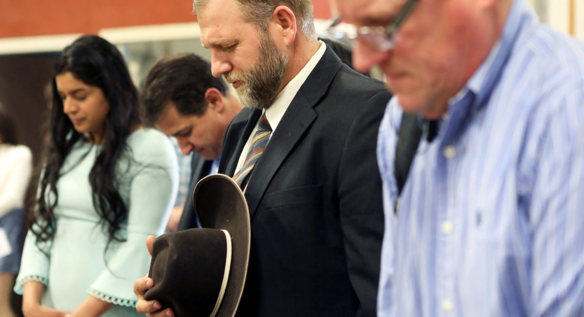 Libertarian activist Ammon Bundy (second from right) prays during an Easter Sunday church service he organized despite concerns over the coronavirus outbreak in Emmett, Idaho. Jim Urquhart/Reuters