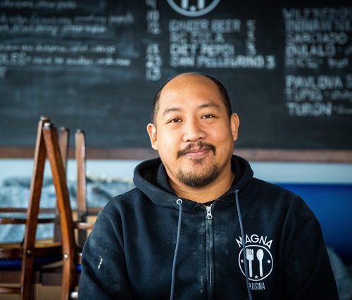 Carlo Lamagna, the owner and chef of Magna Kusina in Portland, Ore., poses for a portrait inside his closed restaurant on Friday, March 27, 2020. Lamagna laid off his entire staff and closed the business following Oregon Gov. Kate Brown’s order to halt dine-in eating at restaurants in response to the coronavirus outbreak. CREDIT: Bryan M. Vance/OPB