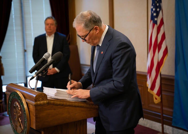 Gov. Jay Inslee signs Washington's supplemental operating budget into law on April 3, 2020. Before doing so, he vetoed more than $200 million in new spending in anticipation of the fiscal impacts of the COVID-19 pandemic. CREDIT: Office of the Governor