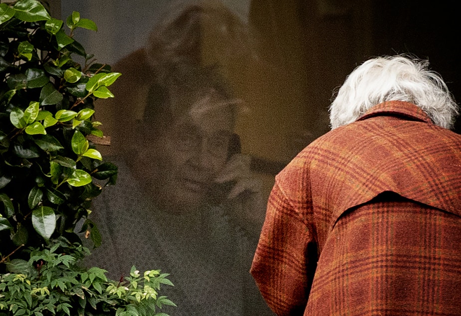 Dorothy Campbell talks to her husband, Gene Campbell, on the phone through his window at the Life Care Center of Kirkland on Thursday, March 5, 2020, in Kirkland. Dorothy's son Charlie Campbell came all the way from Silver City, New Mexico, to bring his mother to see his father. "It’s kind of tough but it’s the best we can do at this point," he said.