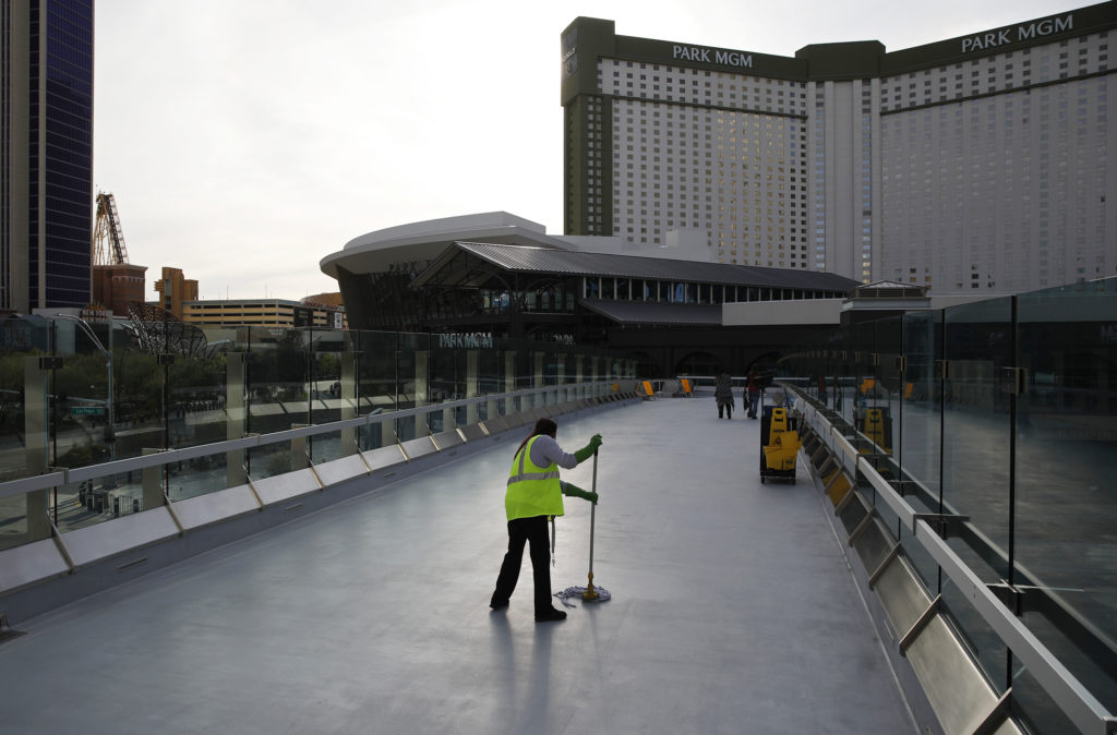 A worker cleans along the Las Vegas Strip, which is nearly empty without the usual crowds as casinos and other businesses are shuttered during the coronavirus outbreak on March 31. John Locher/AP