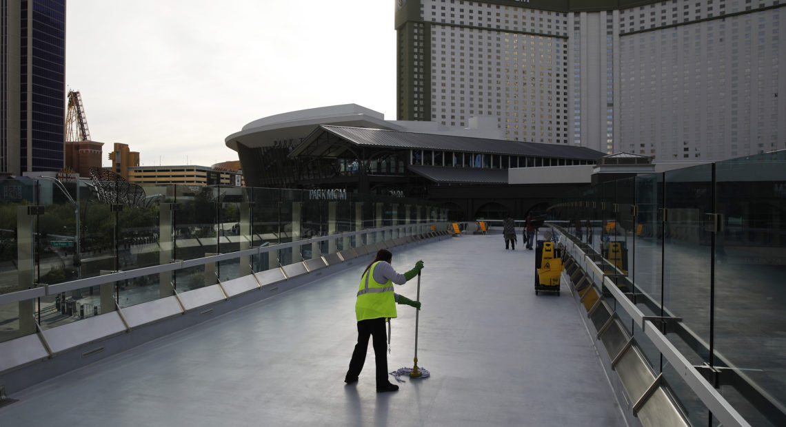 A worker cleans along the Las Vegas Strip, which is nearly empty without the usual crowds as casinos and other businesses are shuttered during the coronavirus outbreak on March 31. John Locher/AP