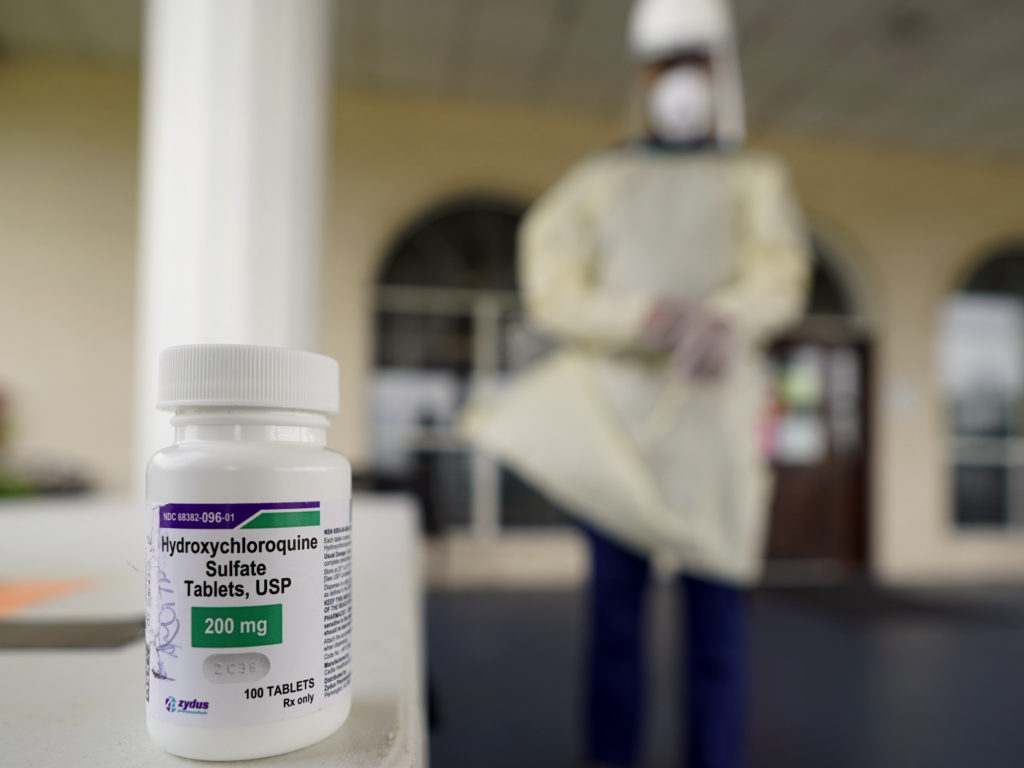 A bottle of hydroxycloroquine sits on a table outside the entrance to The Resort at Texas City nursing home, where Robin Armstrong, a doctor and the home's medical director, is giving the drug to residents CREDIT: David J. Phillip/AP