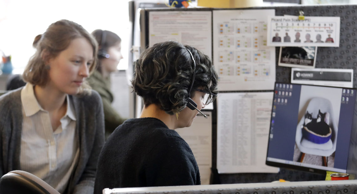 Washington says it will launch contact tracing teams to map coronavirus exposure. Here, public health nurse Jennifer Morgan, right, checks-in via phone with a patient self-quarantined at home in February. University of Washington epidemiology student Erika Feutz observes in Seattle. CREDIT: Elaine Thompson/AP