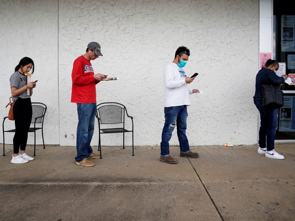 People who lost their jobs wait in line to file for unemployment benefits at an Arkansas Workforce Center in Fayetteville, Ark., on April 6. CREDIT: Nick Oxford/Reuters