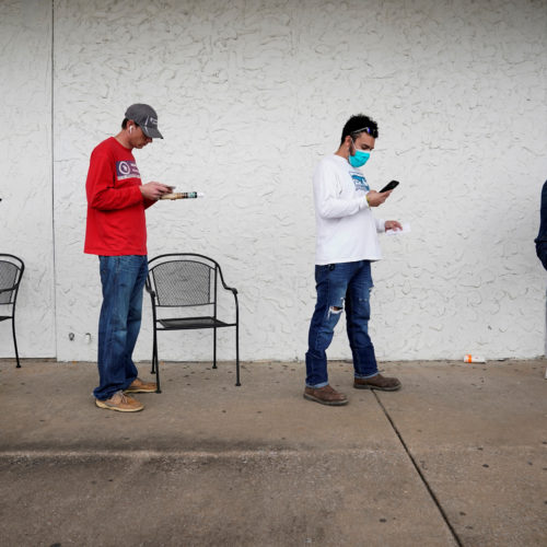 People who lost their jobs wait in line to file for unemployment benefits at an Arkansas Workforce Center in Fayetteville, Ark., on April 6. CREDIT: Nick Oxford/Reuters