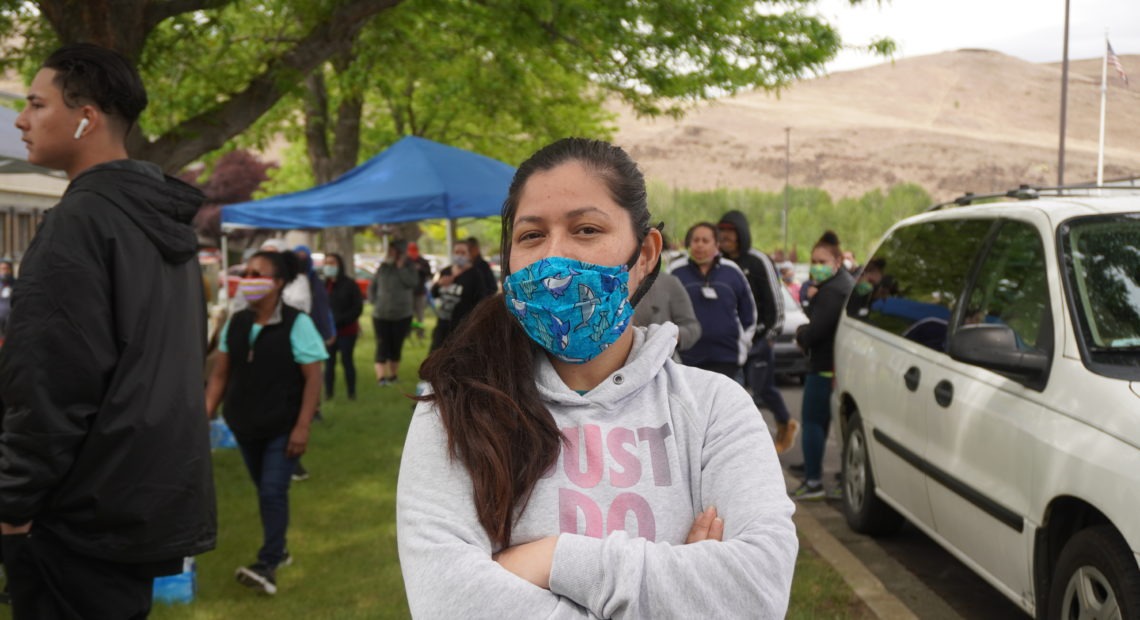 Perla Torres, a fruit packer at Jack Frost Fruit, poses for a photograph wearing a mask she says she bought from a supervisor. CREDIT: Enrique Pérez de la Rosa/NWPB