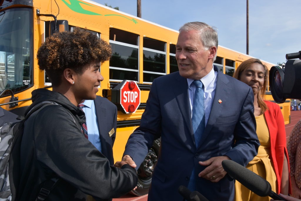 Incoming student body resident Malik Goodrum shakes hands with Gov. Jay Inslee’s hand. On June 17, 2019, Gov. Inslee attended the ribbon-cutting ceremony for the first electric school bus in Washington at Franklin Pierce High School in Tacoma. Courtesy of Washington Governor’s Office
