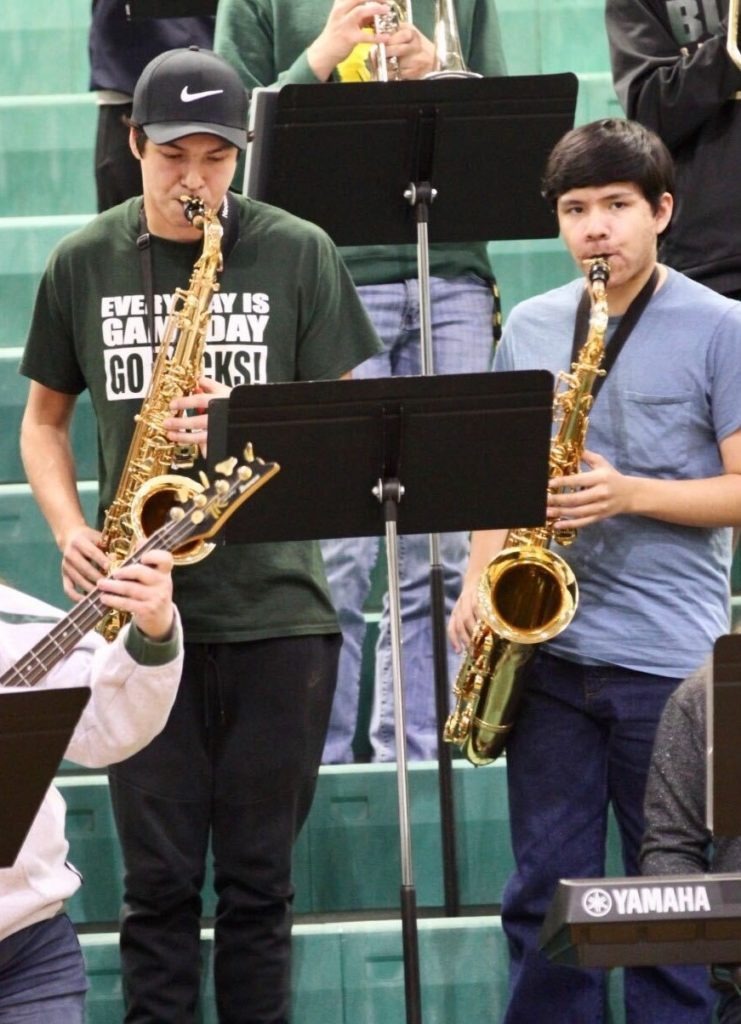 Playing saxophone for his high school band, Marcus Aaron Luke, left, is adjusting to a final semester and a different graduation ceremony.