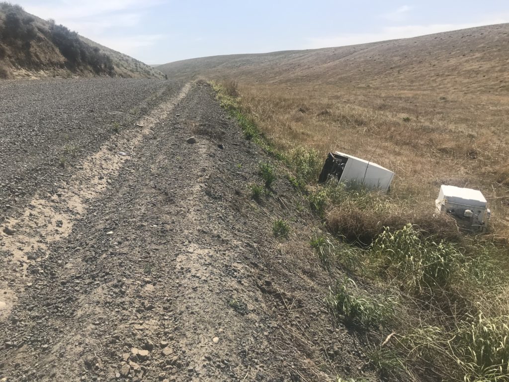 A washing machine was abandoned on the side of the road outside Kennewick. The Washington State Department of Transportation has noticed an uptick in appliances and other junk that’s illegally dumped. CREDIT: Courtney Flatt/NWPB