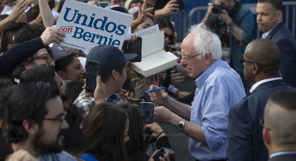 Sen. Bernie Sanders signs autographs at a February campaign event with Latino supporters in Santa Ana, Calif. Some Democrats say the Biden campaign can learn from Sanders' outreach.