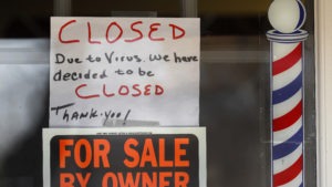 Signs are displayed in the window of a store in Grosse Pointe Woods, Mich. 