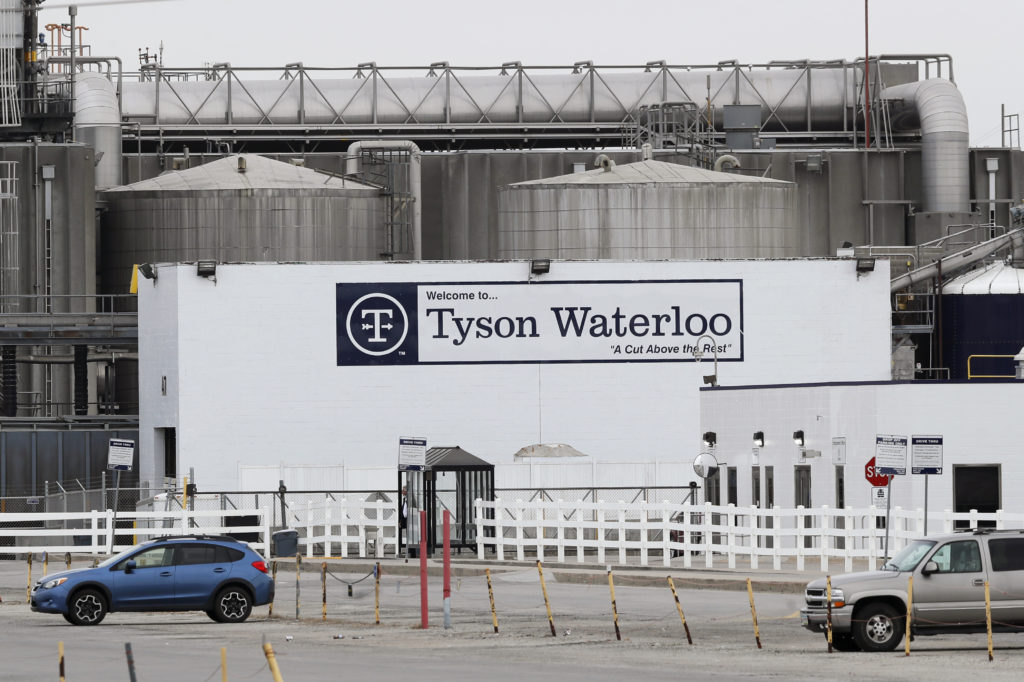 Vehicles sit in a near empty parking lot outside the Tyson Foods plant in Waterloo, Iowa, on May 1. CREDIT: Charlie Neibergall/AP