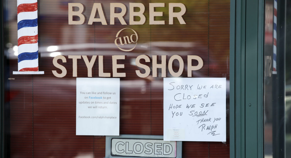 A Seattle barbershop remains closed because of the coronavirus outbreak on May 19. Last week, an additional 2.1 million people filed for unemployment benefits around the country.