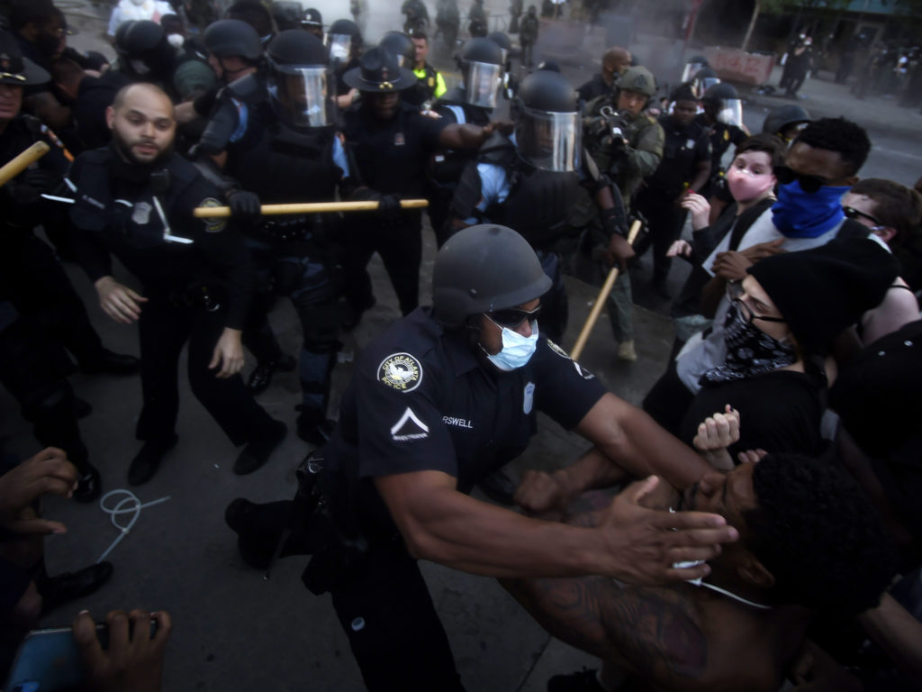 Police officers and protesters clash on Friday near CNN Center in Atlanta, in response to George Floyd's death in police custody in Minneapolis on Memorial Day. CREDIT: Mike Stewart/AP