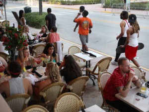 As late as March 17, people eat at a restaurant along Ocean Drive in Miami Beach, Fla., several days after President Trump declared a national emergency.