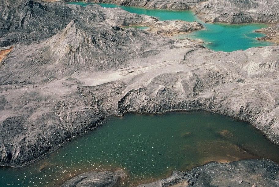 A debris avalanche obliterated forests and and left behind ponds of water surrounded by ash, as seen up close in this 1980 photo. CREDIT: USFS / Public Domain