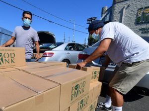 People load their vehicles with boxes of food at a Los Angeles Regional Food Bank earlier this month in Los Angeles. Food banks across the United States are seeing numbers and people they have never seen before amid unprecedented unemployment from the COVID-19 outbreak. 