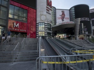 People walk near closed shops on a quiet Las Vegas Strip on May 8. Retail sales dropped a record 16.4% last month.