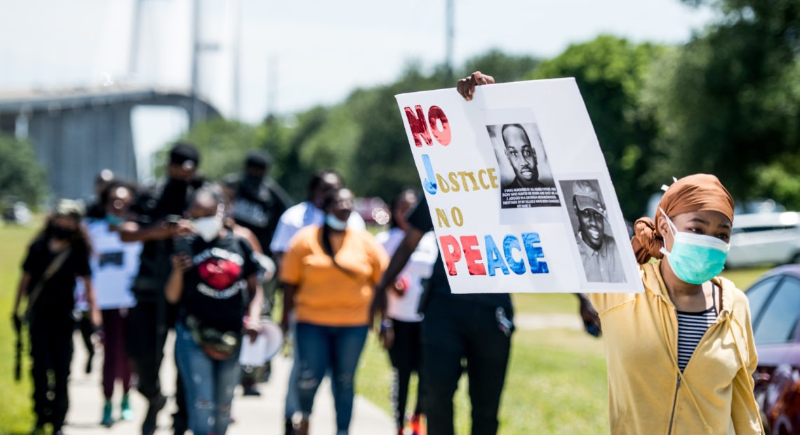 People return to their vehicles after gathering to honor the life of Ahmaud Arbery at Sidney Lanier Park on May 9 in Brunswick, Ga. Arbery was shot and killed while jogging in the nearby Satilla Shores neighborhood on Feb. 23.